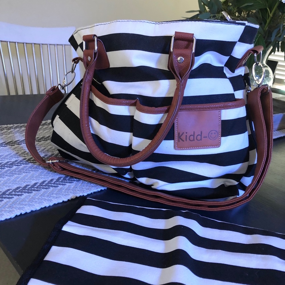 Striped diaper bag with changing pad and strap